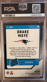A graded 2024 Donruss Optic Drake Maye trading card, PSA 9 Mint Purple Shock, encapsulated in a clear plastic holder and placed on a dark wood background (back of card)